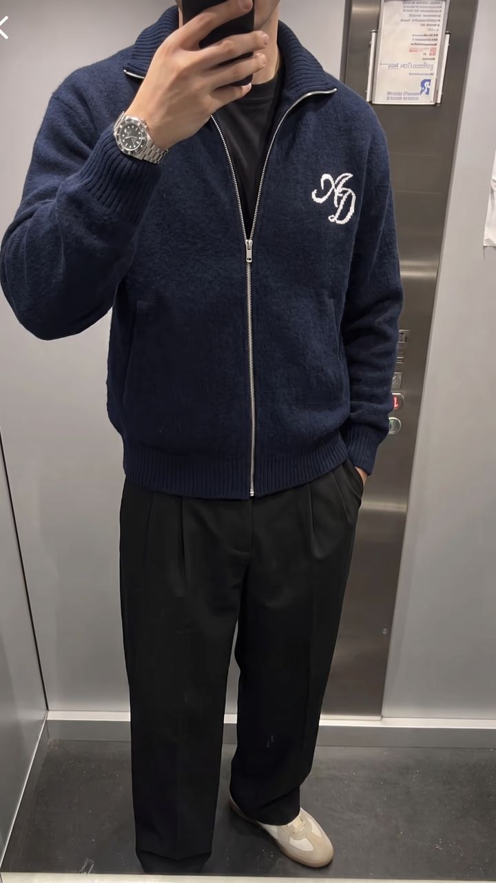 Navy full-zip knit, black pleated trousers